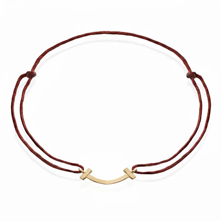 دستبند نخی با پلاک طلا طرح لبخند تیفانی